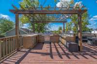 Mega deck in the back of the home. Lots of counter space for hanging out. Grill, will need a new fridge for your keg but all the lines and system is in place. More room to the right with a full outdoor living setup including gas fireplace.