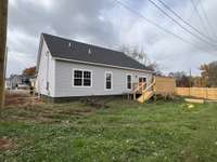 Large backyard with privacy wood fence and deck