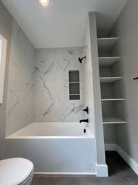 Master tub/shower combo and linen shelving