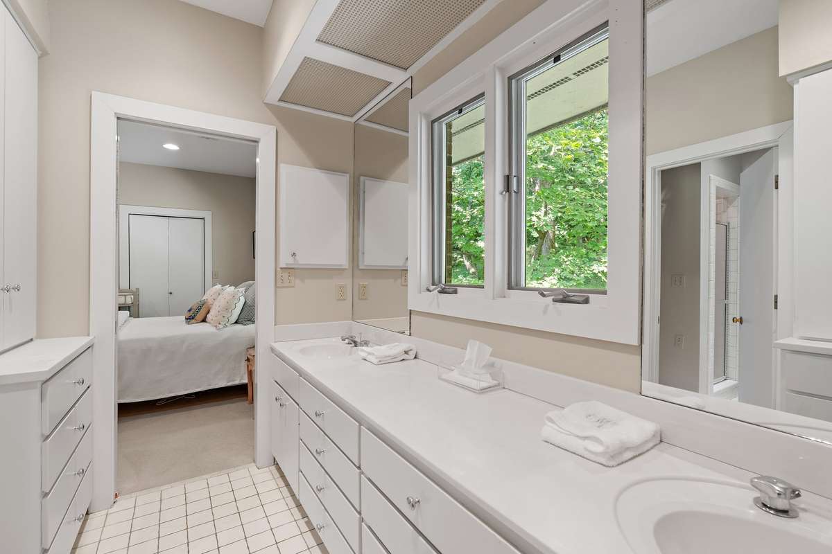 jack and jill bathroom (with pocket doors) featuring a separate shower and tub