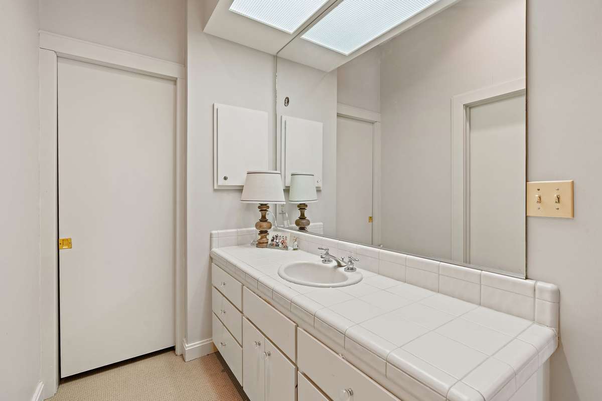 bathroom off bedroom #2. 
the pocket door pictured leads to a walk-in closet