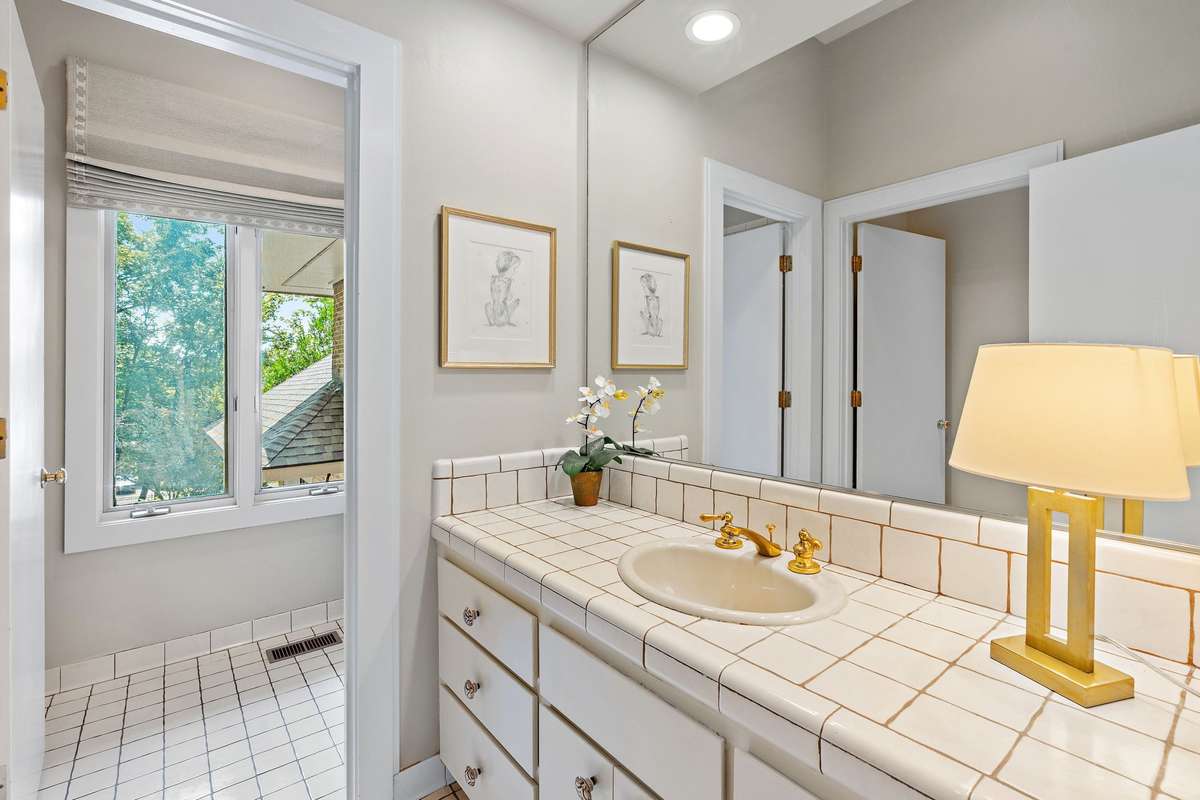 full guest bathroom, conveniently located near the screened-in porch and pool.