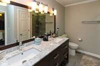 Updated Primary Bath with Double Vanities & tiled flooring!