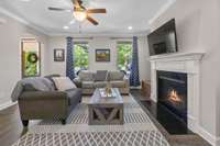 Gorgeous cozy Living Room with custom touches - crown mold, fireplace, hardwoods on main floor.  Powder room is convenient to this room for guests.