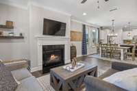 Charming architectural features iin this Living Room include crown mould, a fireplace, hardwoods and a ceiling fan.  Powder room is just off living room.