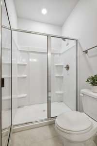 Photo of similar home in the same community. Primary bathroom with walk-in shower.