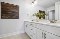 Photo of similar home in the same community. Guest Bathroom w/ standard 2 sinks and quartz countertops.