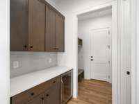 The garage entry offers a mudroom as well as additional pantry with a beverage cooler