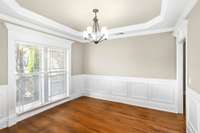 The dining room has beautiful molding and wainscotting which adds so much character and charm to the space!