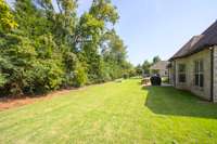 The backyard offers space to add more garden beds.