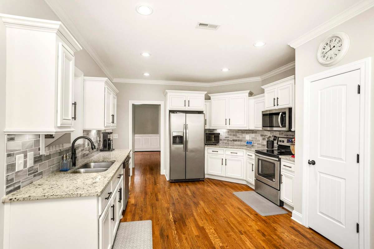 Enjoy a modern kitchen with granite countertops, stainless steel appliances, and a large pantry.