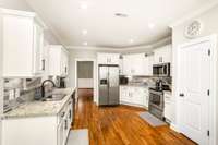 Enjoy a modern kitchen with granite countertops, stainless steel appliances, and a large pantry.