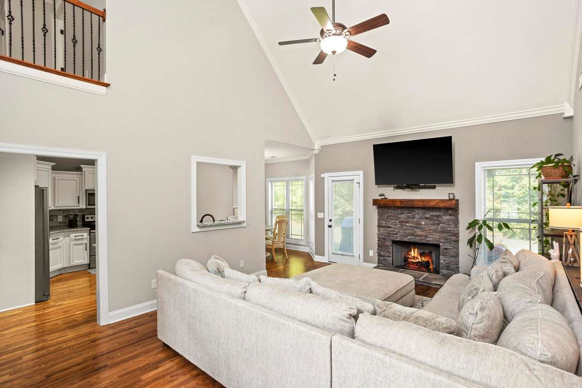 The cafe window and spacious doorways allow quick access between the living room and kitchen.