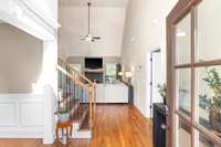 Just inside the foyer, the dining room is located to the left, the living room ahead, and the primary suite to the right.