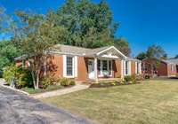 Welcome home to 363 Flushing Drive on a half acre lot perfectly positioned in the community for access and privacy and within walking distance to Whitsett Park along Mill Creek.