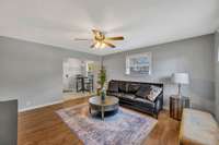 As you come in Living Room has real sand & finish hardwood floors. Ceiling Fan and Lots of Natural Light