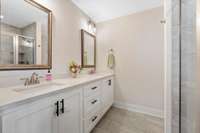 Double vanities and quartz countertops in the primary bathroom