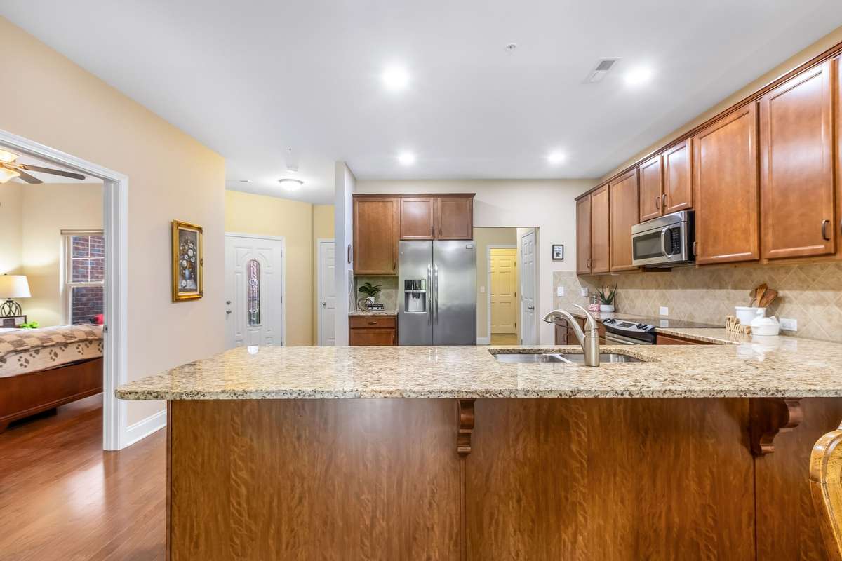 Expansive countertops, timeless finishes, and abundant storage make this kitchen the true heart of the home. Complete with a pantry just in view.