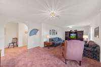 Arched doorway leads to the hallway and primary bedroom for this side of the house.