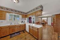 Very spacious kitchen and dining area. If wallpaper isn't your thing, change it to make it something you love. The space easily flows from the living room to the Florida room.