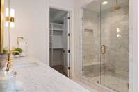 Primary walk in shower with standard and rain shower heads