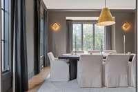 Formal dining room, moody and featuring accent lighting