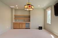 Game room features bar with drink fridge