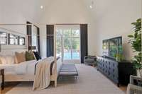 Primary suite on main floor.  Vaulted ceiling and looks out on to pool