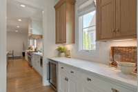 Butler's pantry with wine fridge is located between the kitchen and formal dining room