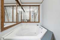 Built in tub with surrounding mirrors in the primary bath.  1565 Eugene Reed Rd Woodbury TN 37190