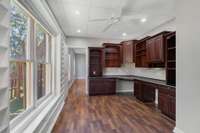 Built-in home office featuring rich custom cabinetry, and a functional design that blends productivity with style.