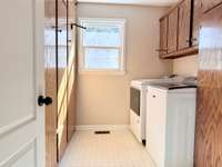 Separate laundry room off the Primary Bedroom hallway