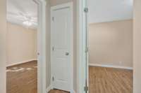 From the hall showing primary bedroom and bedroom 3 with the closet in between.