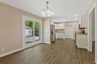 Another wide view of the kitchen and eating area.
