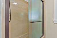 This is the hall bath that was renovated a few years ago. Combination shower with sliding glass doors.