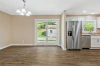 Spacious dining area with new light fixture. Atrium doors leading to the patio.
