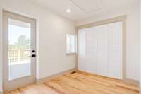 Laundry room behind the sliding doors + door leading to back deck