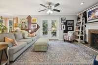 Family room with a wood burning fireplace and a beautiful view of the back yard.