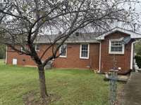 Back of house with side patio