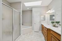 Primary bath #1 with separate shower and jetted soaking tub, double vanities, and skylights.