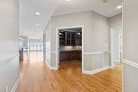 Office with french doors for privacy with built-in desk and cabinetry.