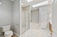 Primary bath #1 with separate shower and jetted soaking tub, double vanities, and skylights.