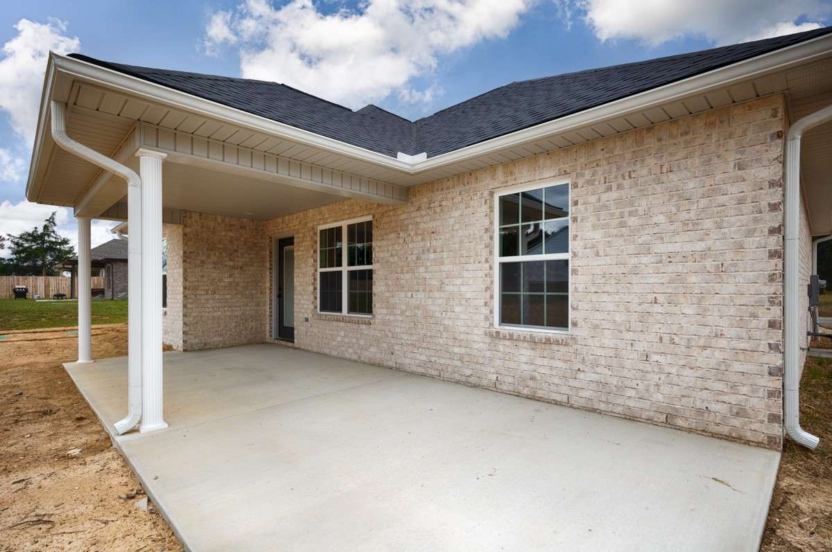 Back of house- covered patio with home entry, open patio