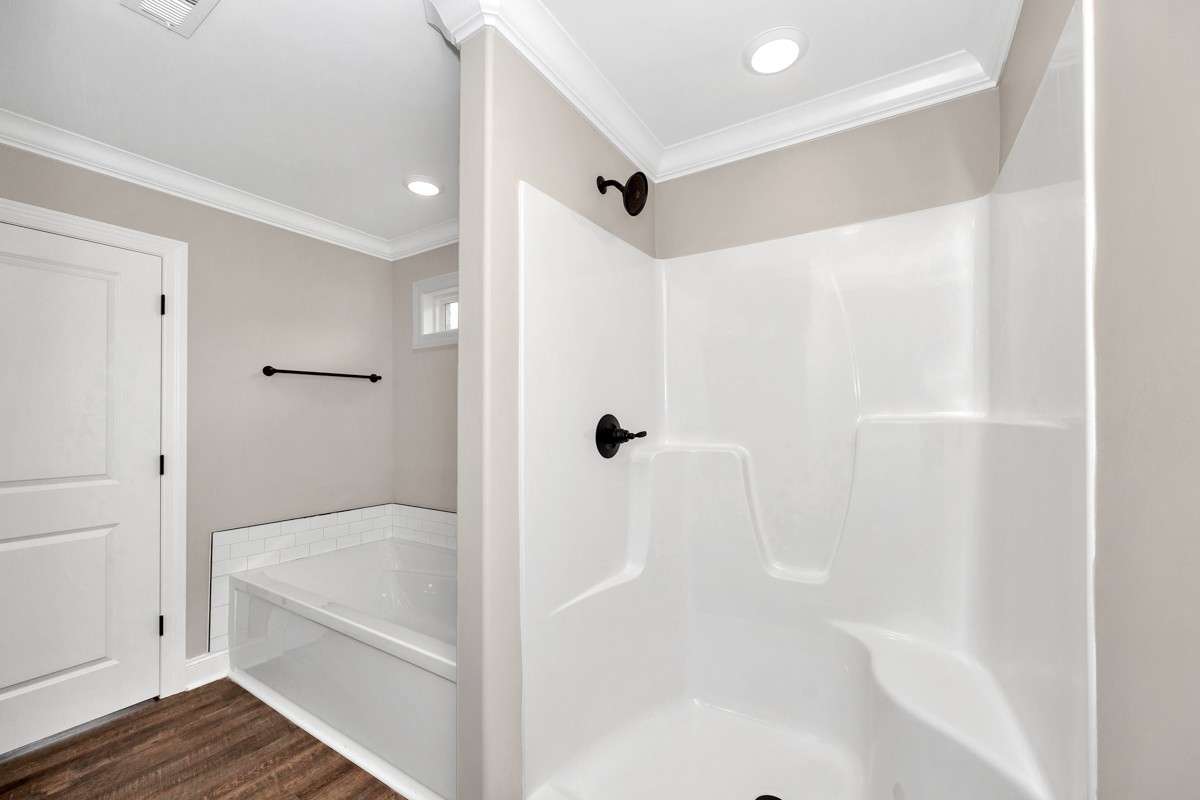 Primary Bath- LVP flooring, crown molding, separate tub & shower, double vanities