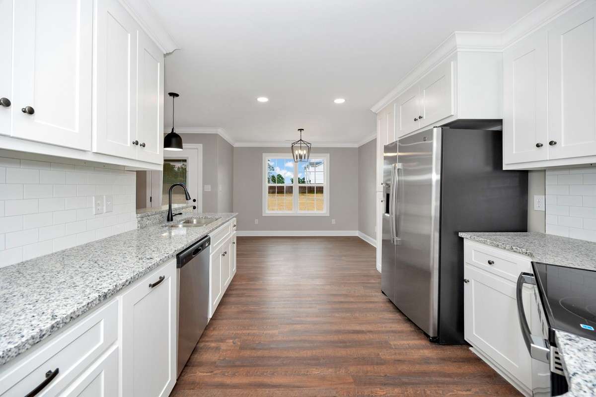 Kitchen- LVP flooring, granite countertops, pantry, recessed lighting, stainless steel appliances- dishwasher, refrigerator, stove/oven, microwave, crown molding