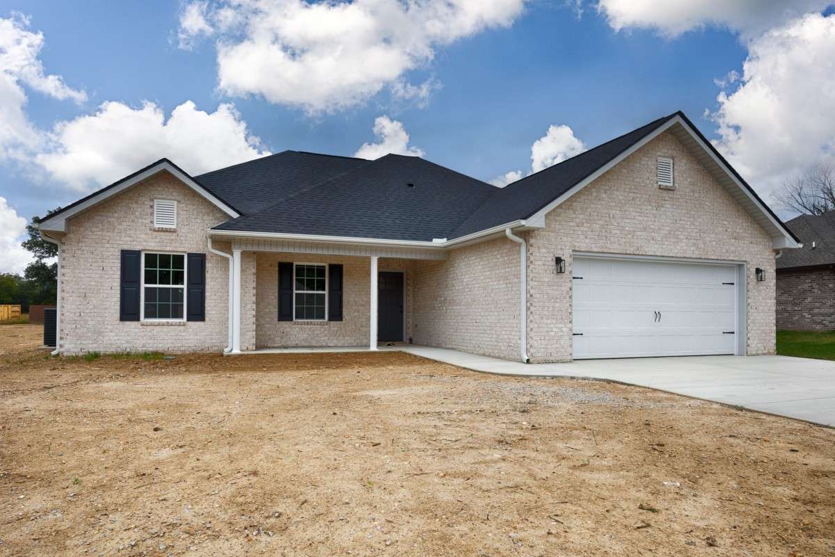 Front of house- Full brick, two-car attached garage, concrete driveway and sidewalk, covered front porch with home entry