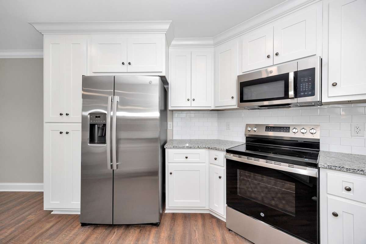 Kitchen- LVP flooring, granite countertops, pantry, recessed lighting, stainless steel appliances- dishwasher, refrigerator, stove/oven, microwave, crown molding