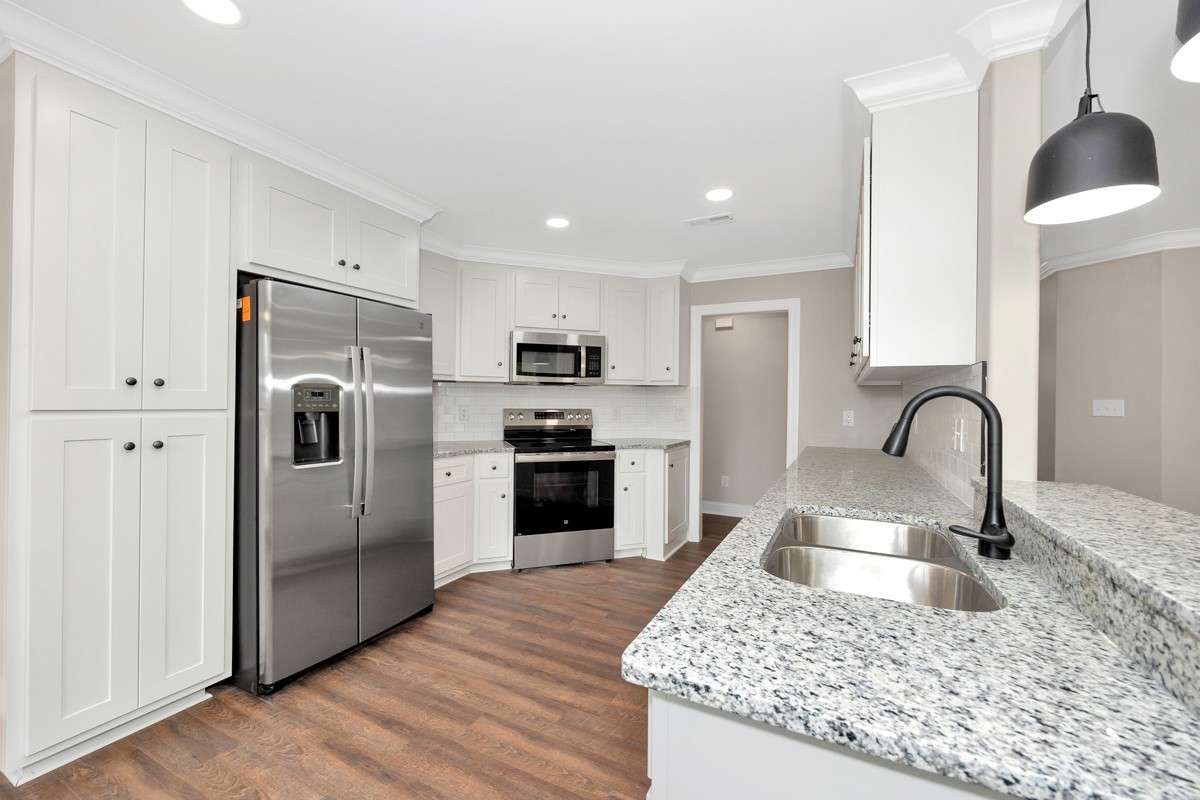 Kitchen- LVP flooring, granite countertops, pantry, recessed lighting, stainless steel appliances- dishwasher, refrigerator, stove/oven, microwave, crown molding