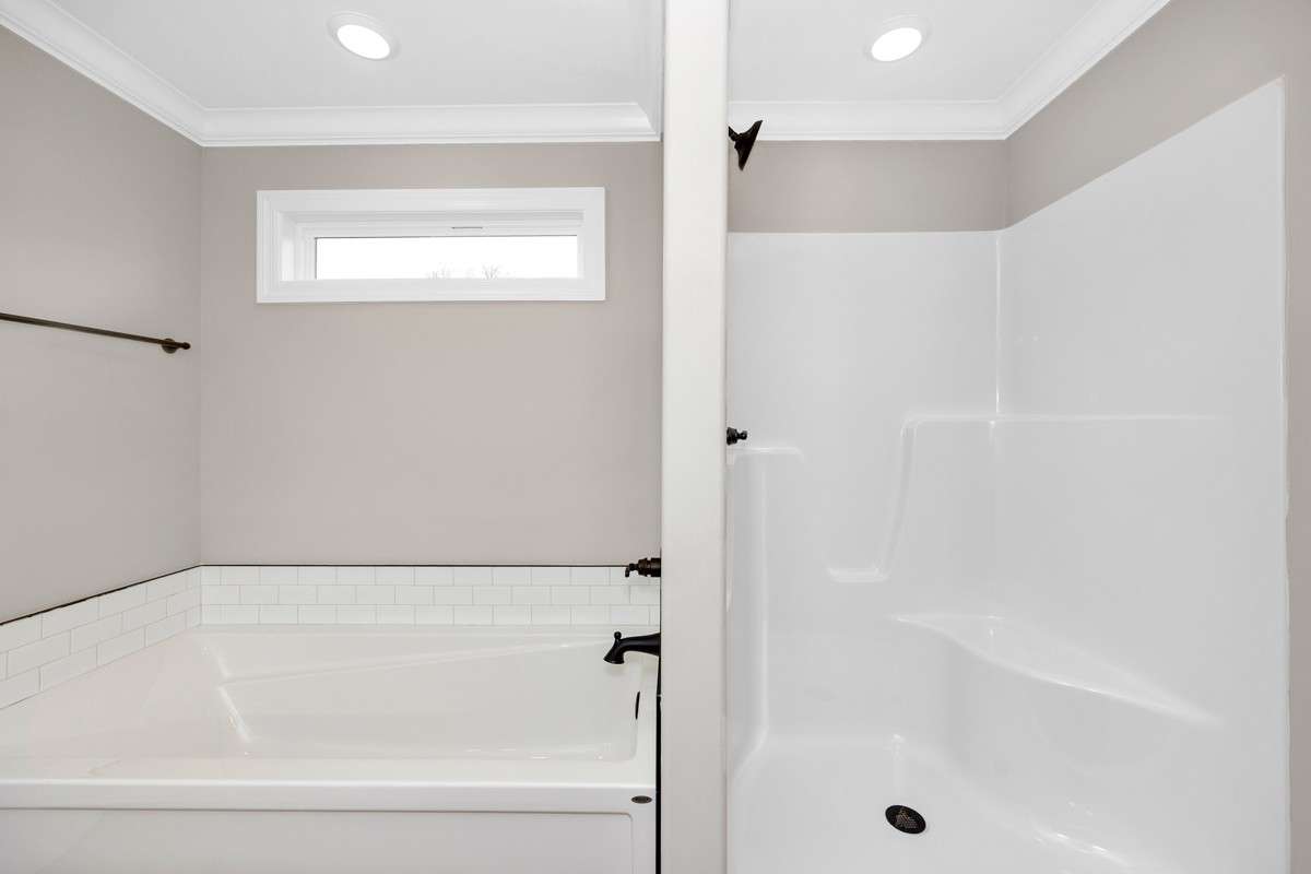 Primary Bath- LVP flooring, crown molding, separate tub & shower, double vanities