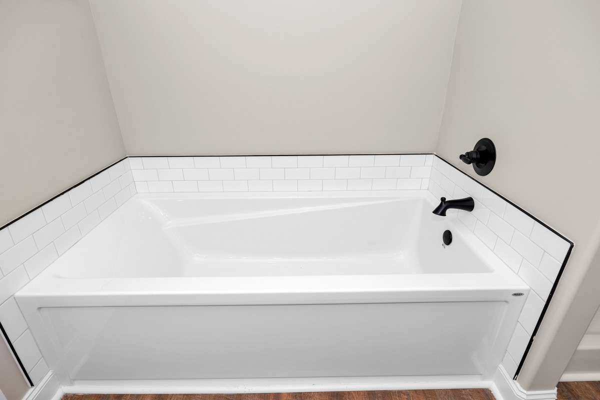 Primary Bath- LVP flooring, crown molding, separate tub & shower, double vanities